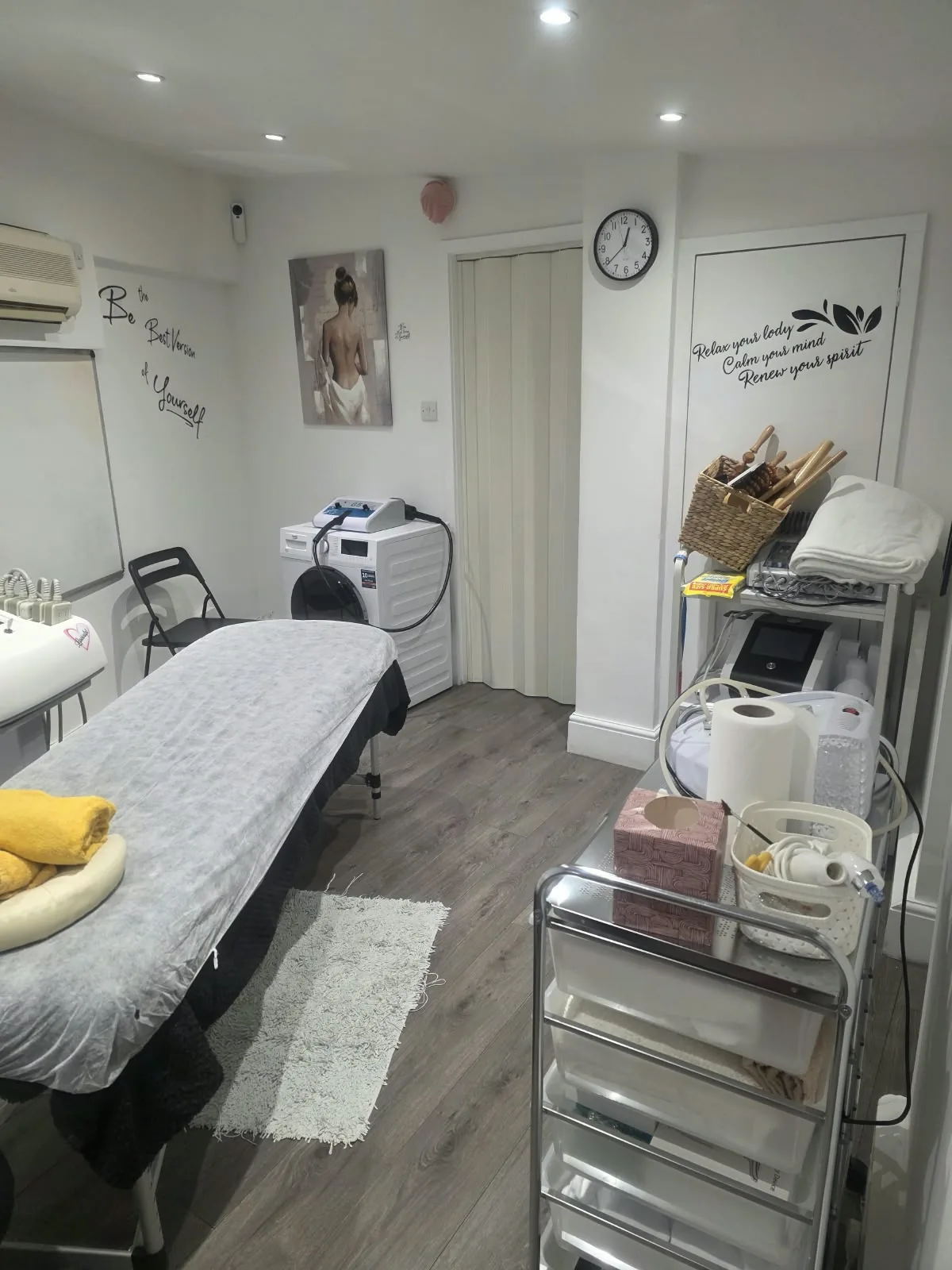 Treatment room with wall messages and equipment trolley